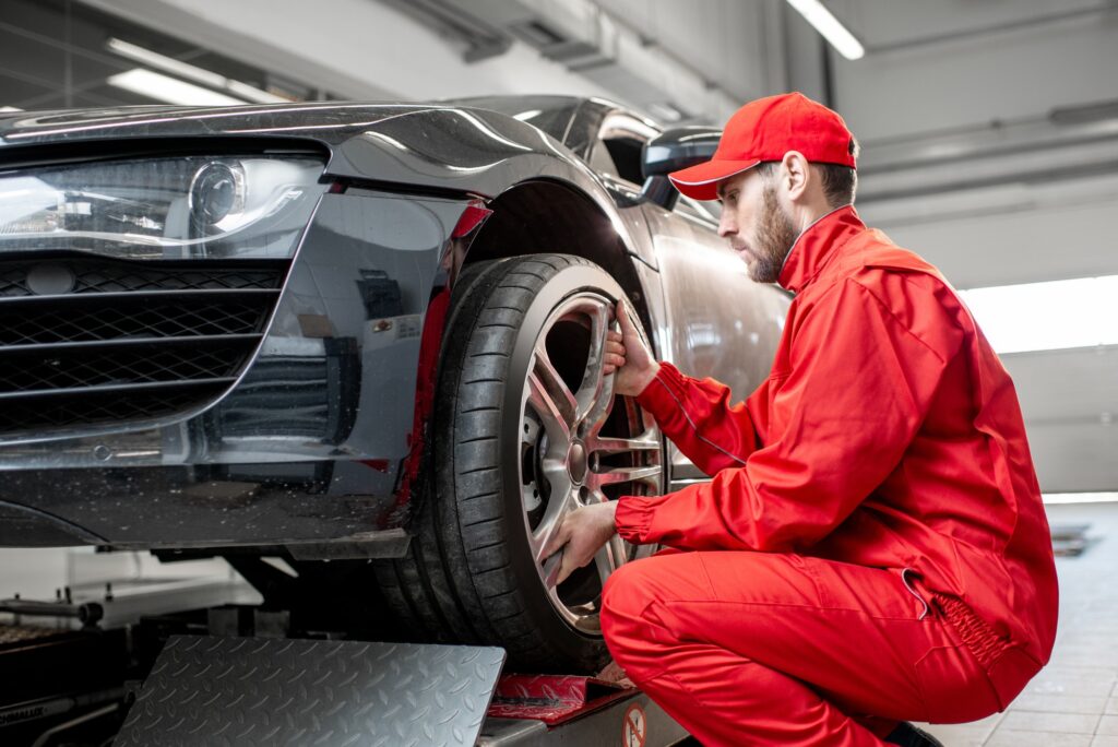 car-service-worker-changing-wheel.jpg