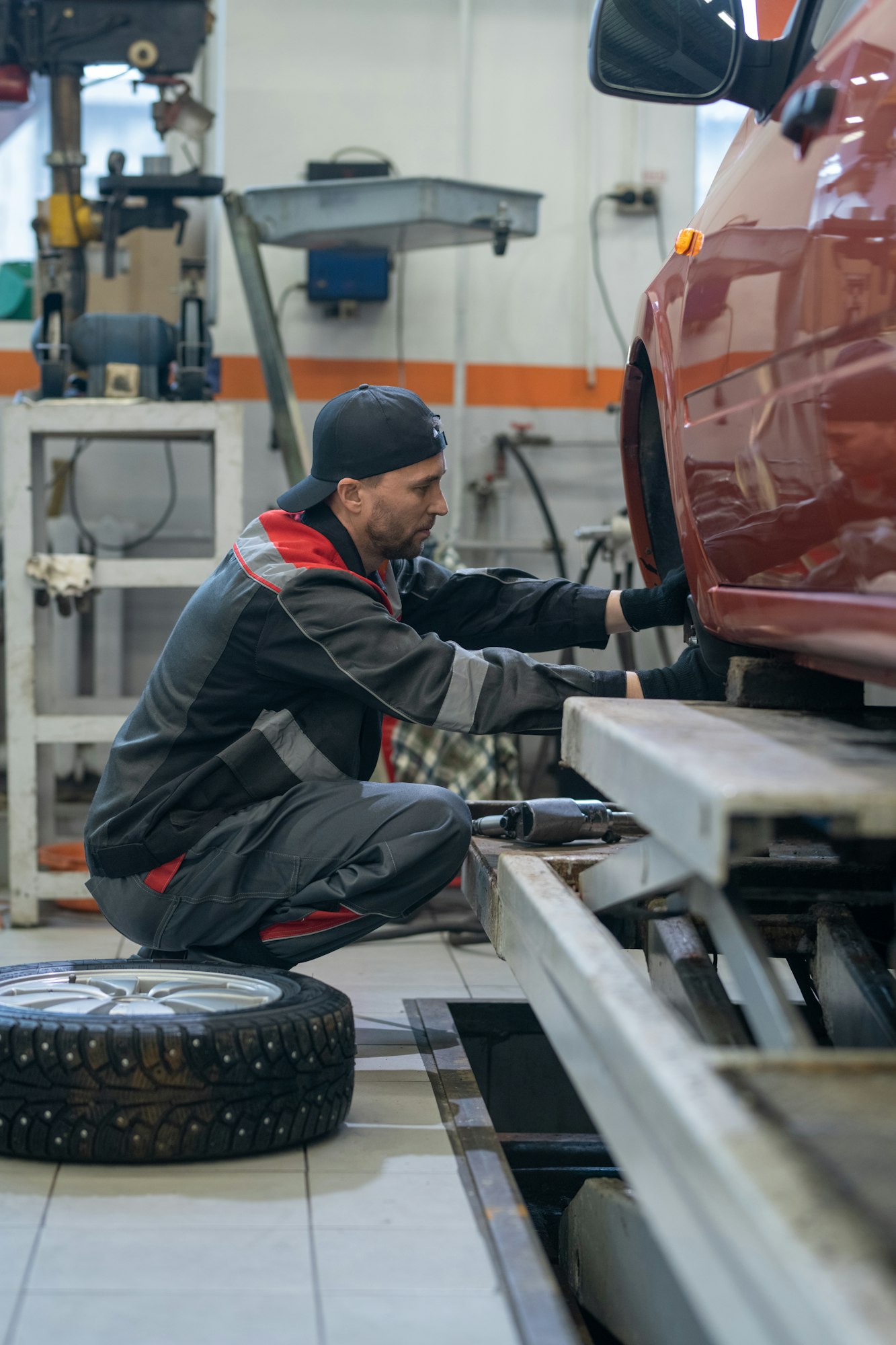 Mechanic Changing Tires in Car Repair Shop